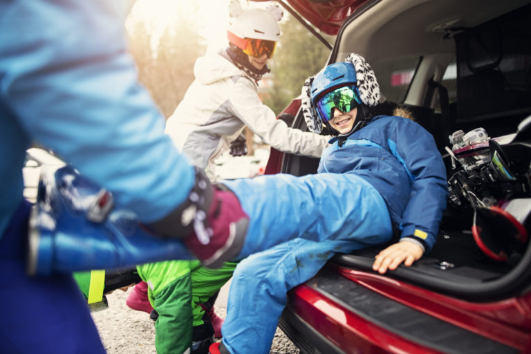 family-taking-off-ski-boots-after-skiing